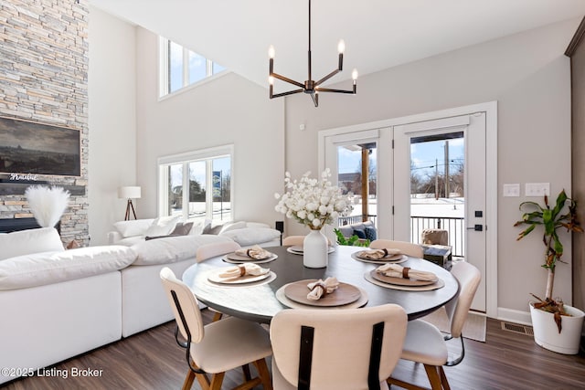 dining space with dark wood-style flooring and a healthy amount of sunlight