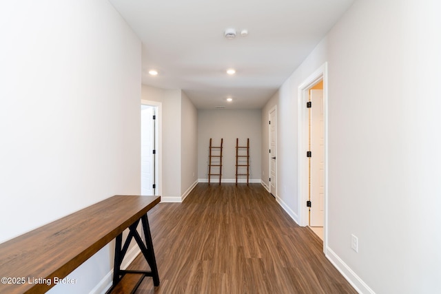 hall featuring dark wood-style floors, recessed lighting, and baseboards