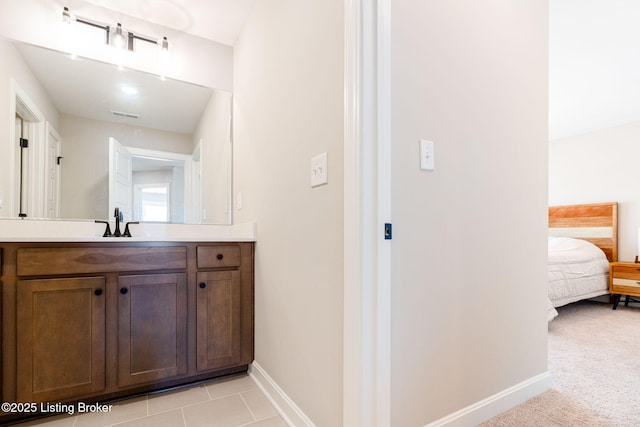 ensuite bathroom with ensuite bath, visible vents, baseboards, and vanity