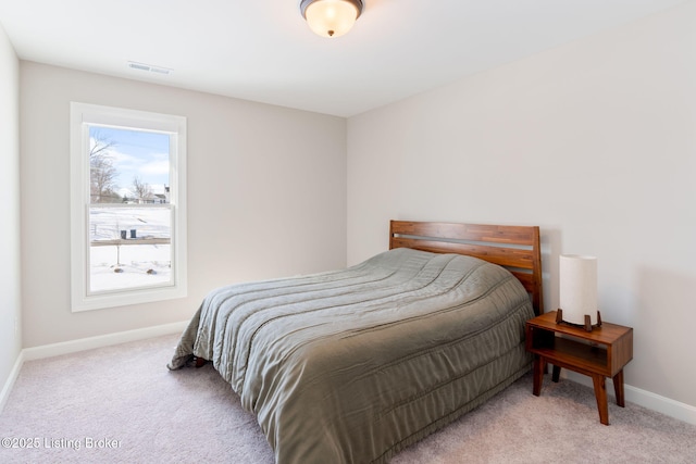 bedroom featuring light colored carpet, visible vents, and baseboards