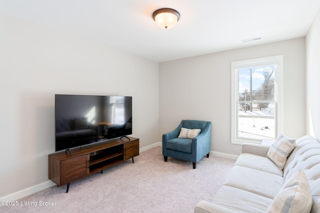 living area featuring light carpet, visible vents, and baseboards