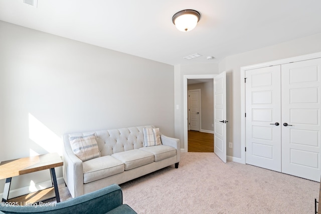 living room featuring light carpet and baseboards