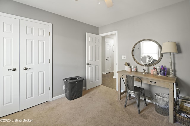 office featuring carpet flooring, a ceiling fan, and baseboards