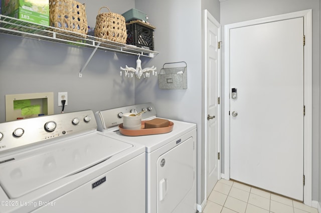 laundry room with laundry area, light tile patterned flooring, and separate washer and dryer