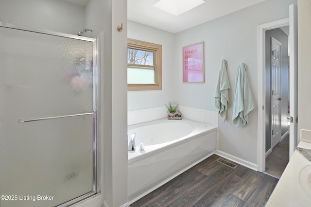 full bath with wood finished floors, a stall shower, vanity, and a bath