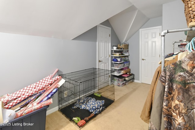 carpeted bedroom featuring lofted ceiling and baseboards