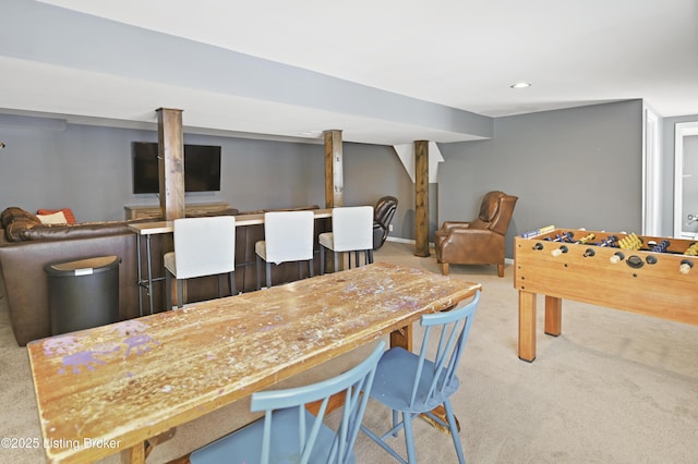 playroom featuring baseboards, a bar, and light colored carpet