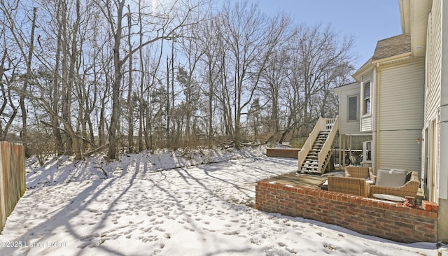 yard layered in snow with fence and stairs