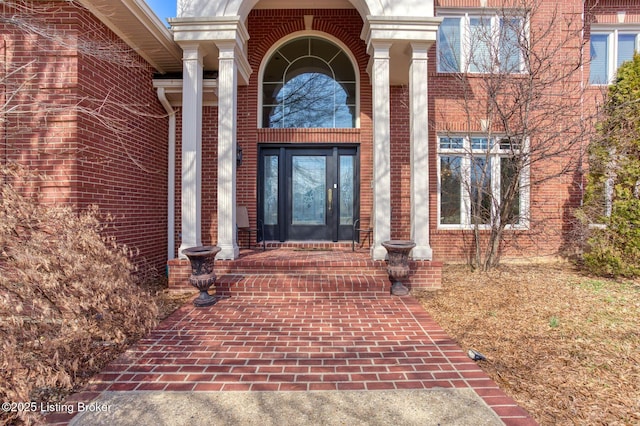 view of exterior entry with brick siding