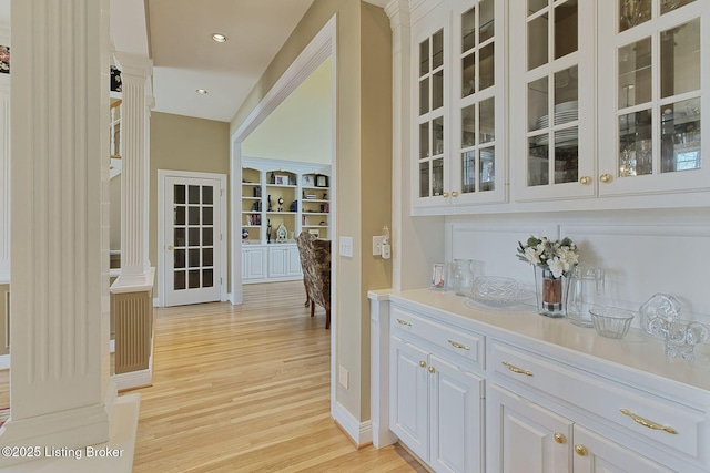 bar with light wood-style flooring, baseboards, and recessed lighting