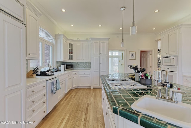 kitchen with appliances with stainless steel finishes, a sink, and white cabinetry