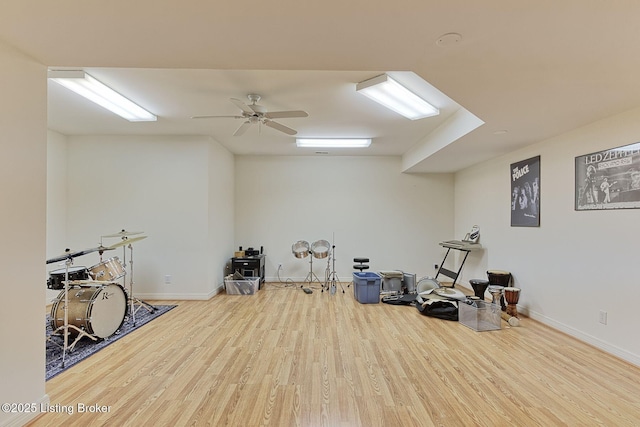 miscellaneous room with a ceiling fan, baseboards, and wood finished floors