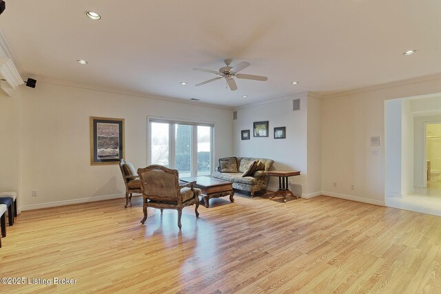 living area featuring crown molding, recessed lighting, light wood-type flooring, and baseboards