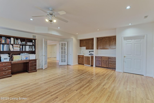 kitchen with dishwashing machine, recessed lighting, light countertops, french doors, and light wood-type flooring