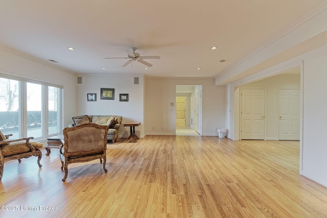 living room with baseboards, ornamental molding, recessed lighting, and light wood-style floors