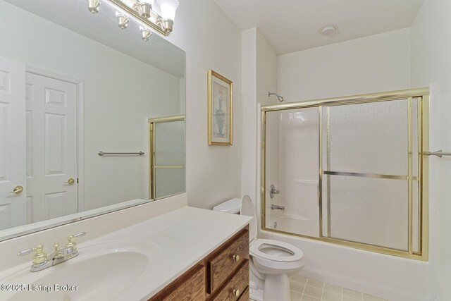 bathroom featuring toilet, shower / bath combination with glass door, and vanity