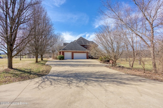 view of side of home featuring a garage and concrete driveway