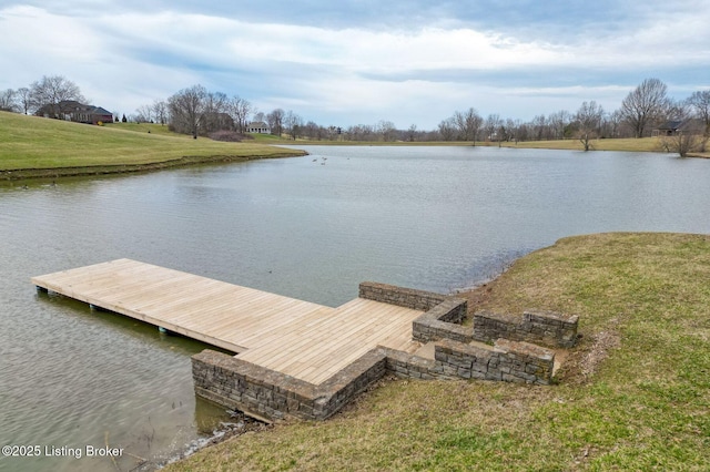 dock area with a water view and a yard