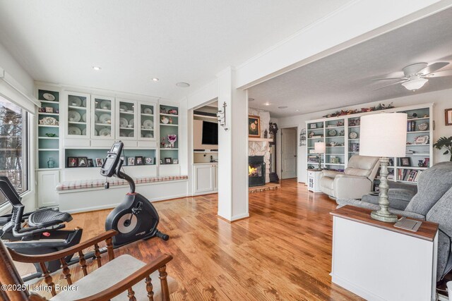 950 Lakeview Dr, Bloomfield, KY 40008 - exercise room featuring a ceiling fan, a fireplace, and light wood-style floors