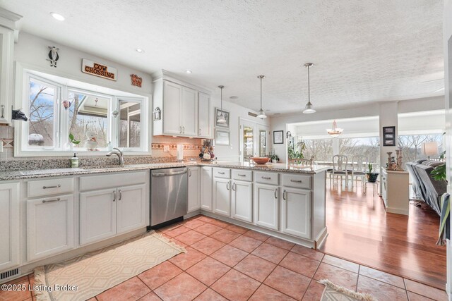 950 Lakeview Dr, Bloomfield, KY 40008 - kitchen with backsplash, decorative light fixtures, dishwasher, a peninsula, and light tile patterned flooring