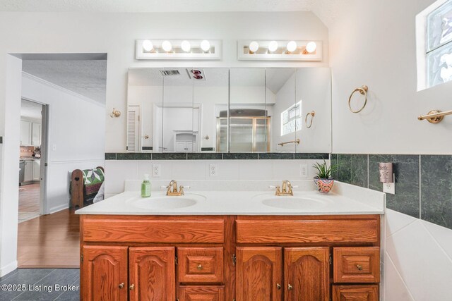 950 Lakeview Dr, Bloomfield, KY 40008 - full bath with a sink, tile walls, a shower stall, and double vanity