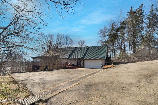 950 Lakeview Dr, Bloomfield, KY 40008 - view of property exterior with metal roof, an attached garage, and driveway