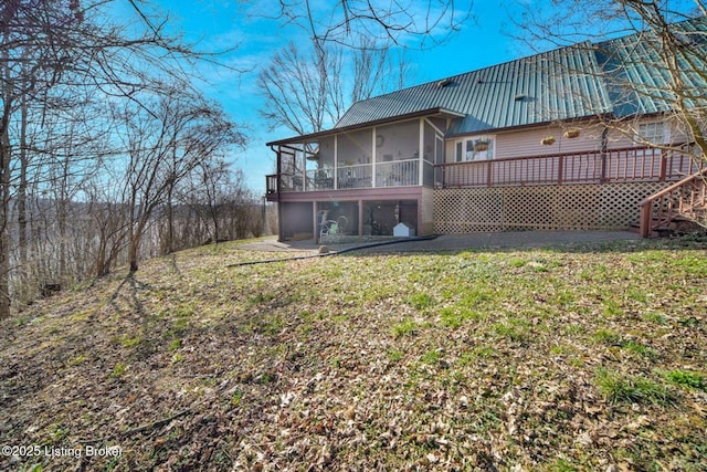 950 Lakeview Dr, Bloomfield, KY 40008 - back of property featuring a wooden deck, a lawn, a sunroom, and metal roof