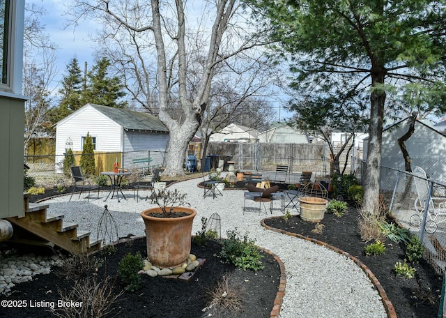 view of yard featuring a fire pit, a patio area, and a fenced backyard