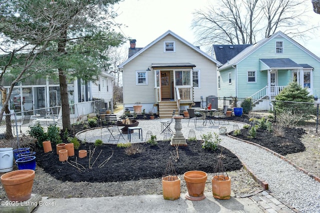 rear view of house with an outdoor fire pit, a patio, a chimney, and fence