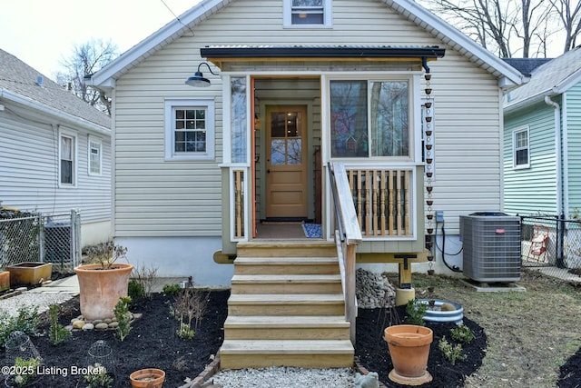 view of front of property with fence and cooling unit