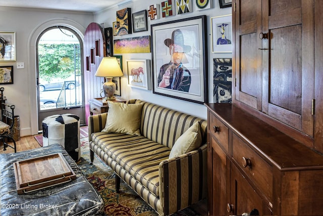 living area featuring light wood-type flooring and ornamental molding