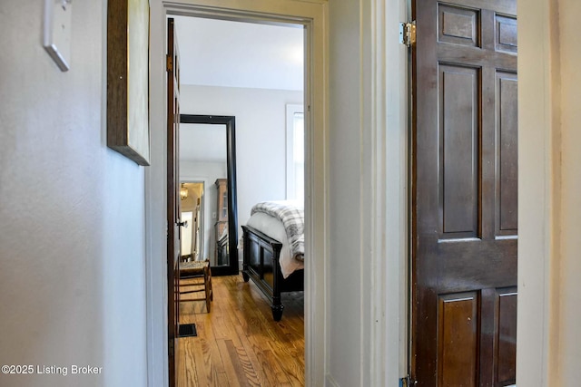 hallway with visible vents and light wood-style floors