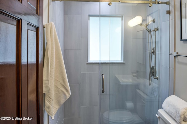 full bathroom with a stall shower and toilet