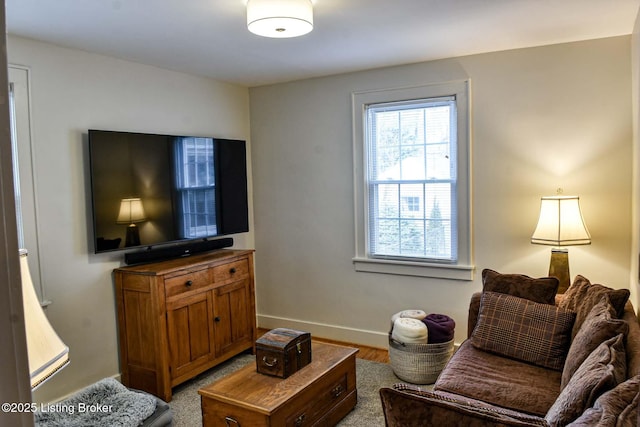 living area featuring light wood-type flooring and baseboards