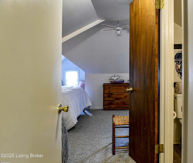 carpeted bedroom with vaulted ceiling and baseboards