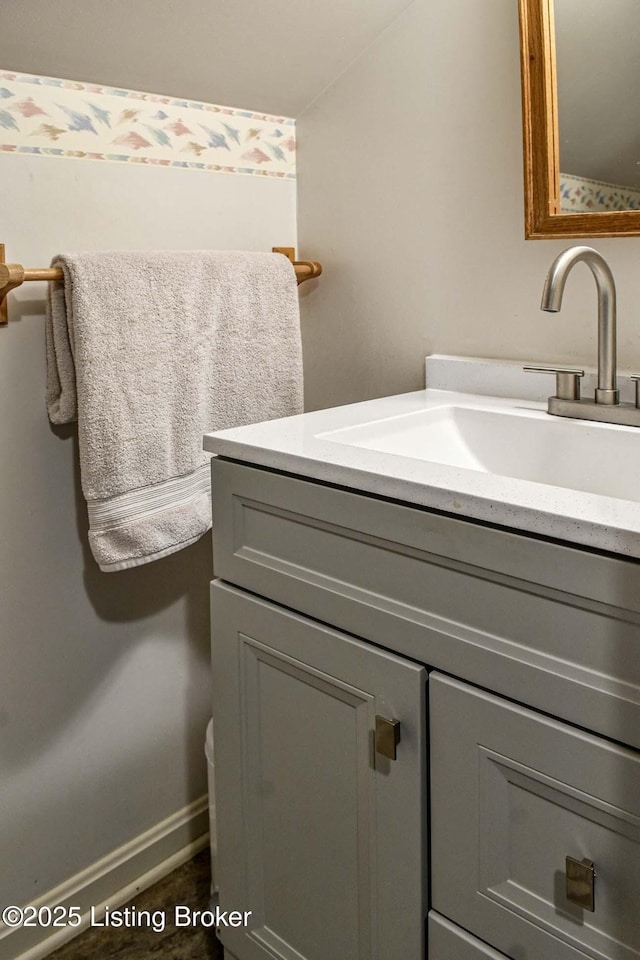 bathroom with vanity and baseboards