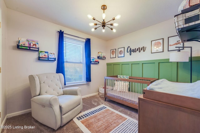 carpeted bedroom with a chandelier and baseboards