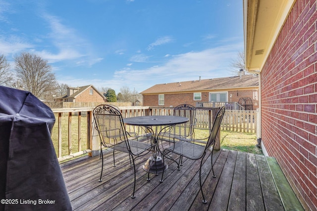 wooden deck with fence and outdoor dining area