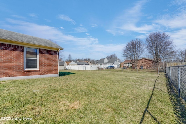 view of yard with a residential view and a fenced backyard