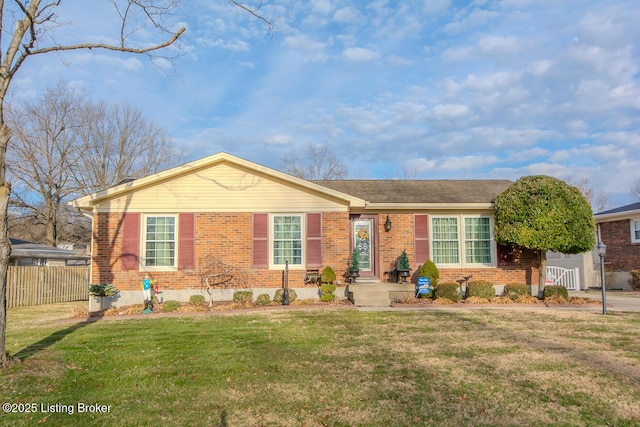 single story home with a front yard, fence, and brick siding