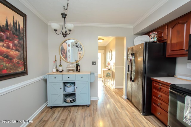 kitchen with ornamental molding, light wood-type flooring, light countertops, and black appliances