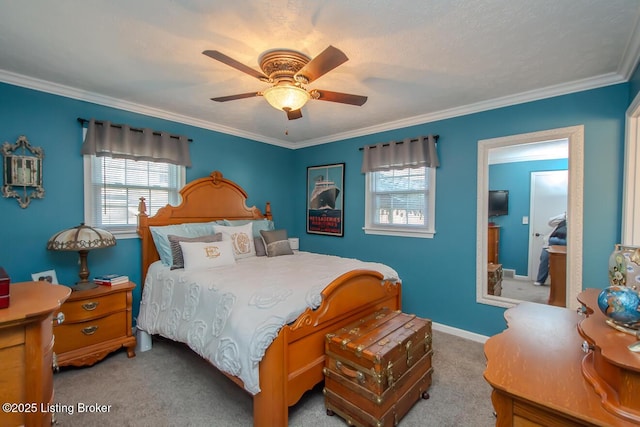 carpeted bedroom featuring ceiling fan, baseboards, and crown molding