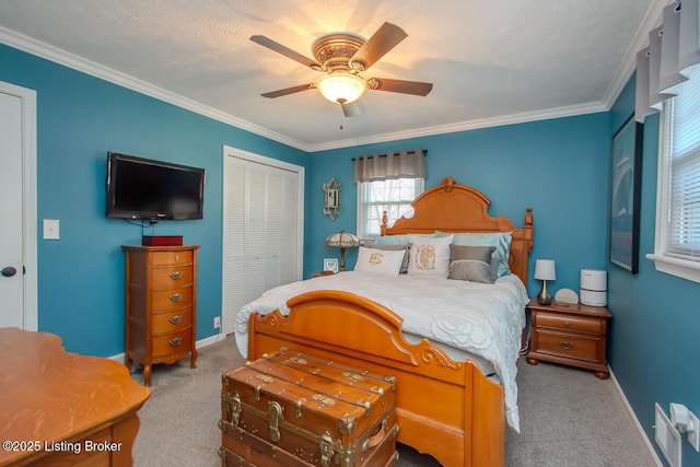 bedroom with carpet floors, a closet, crown molding, and baseboards