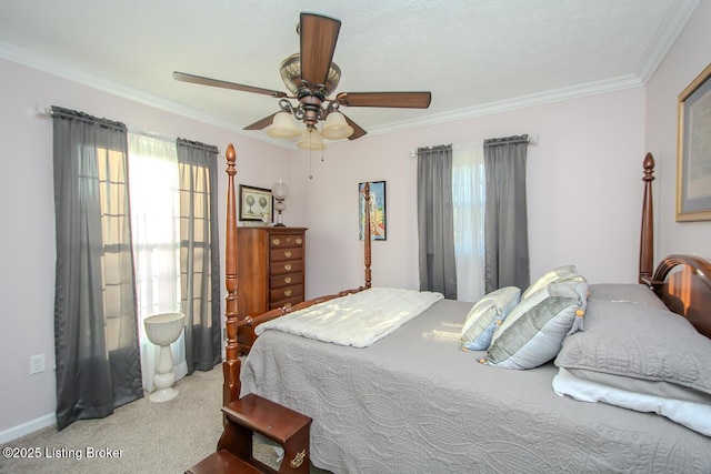 carpeted bedroom featuring ornamental molding and a ceiling fan