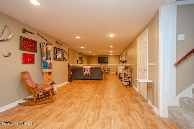 living room featuring light wood-style floors, stairs, baseboards, and recessed lighting