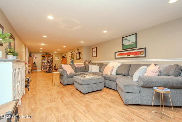 living room with light wood finished floors and recessed lighting