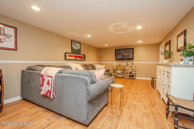 living area with baseboards, recessed lighting, and light wood-style floors