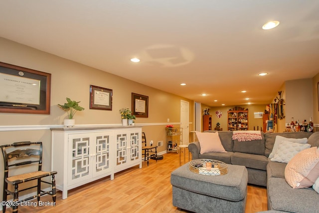 living room featuring recessed lighting, baseboards, and wood finished floors