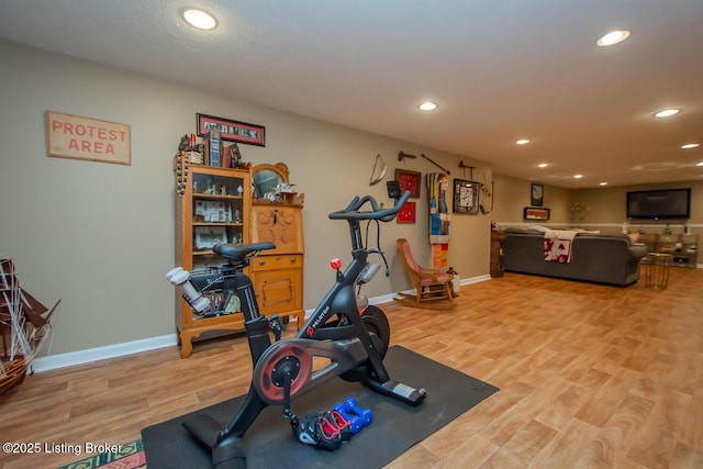 workout area featuring recessed lighting, baseboards, and wood finished floors