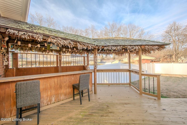 wooden terrace featuring fence